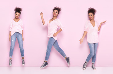 Happy afro girl with amazing smile posing on pink background.