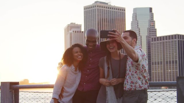 Group Of Friends Posing For Selfie In Front Of Manhattan Skyline