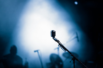 microphone in stage lights during concert - summer music festival