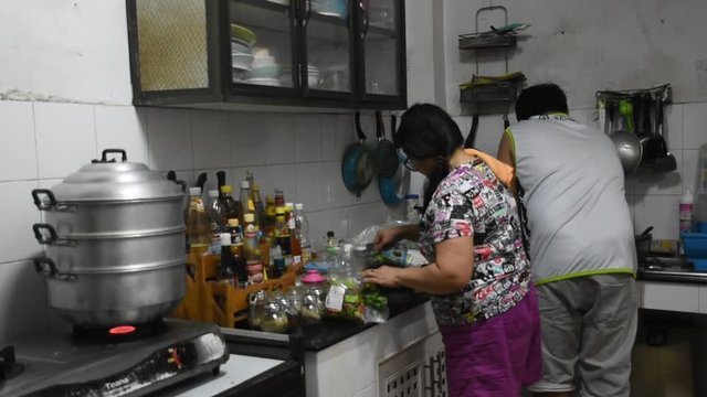 Asian thai family mother and son cooking and prepare dinner for dining in local kitchen room thai style at my house on January 13, 2018 in Nonthaburi, Thailand