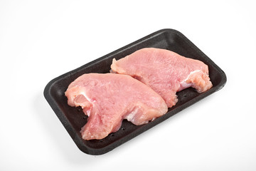 Raw turkey meat in tray, isolated on white background