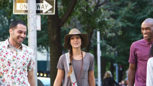 Group Of Friends Walking Along Urban Street In New York City
