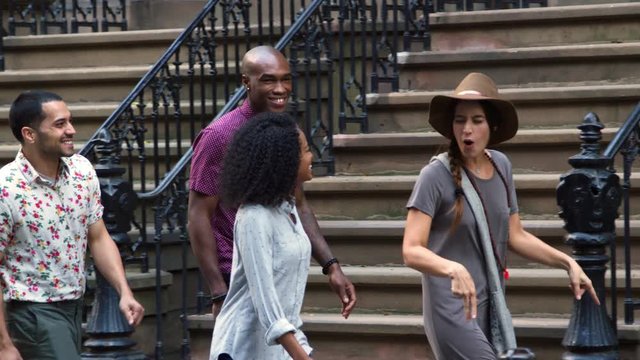 Group Of Friends Walking Along Urban Street In New York City