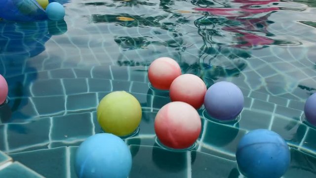 Toy ball rubber floating on the pool water for people play at resort in Phetchaburi, Thailand