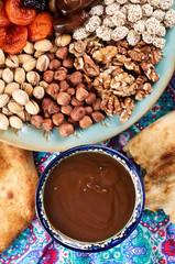 Traditional Azerbaijan sweet cuisine of holiday Nowruz: national dessert Sumalak, assortment of nuts and dry fruits