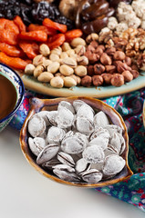 Traditional Azerbaijan sweet cuisine of holiday Nowruz: apricot bones fried with salt, assortment of nuts and dry fruits