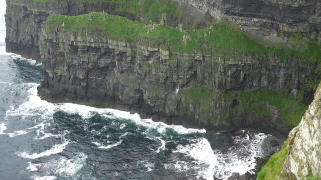 High angle view of waves crashing into cliffs 