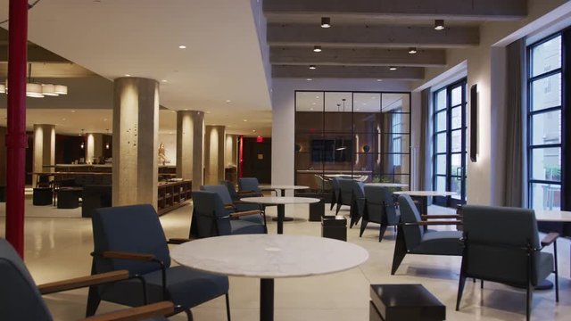Tables and chairs in empty furnished business lobby interior
