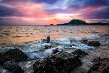 beautiful seascape with sunset rock water and clouds background
