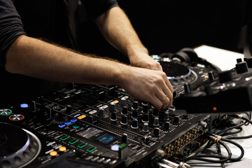 Fototapeta na wymiar dj hands mixing tracks on sound mixer controller