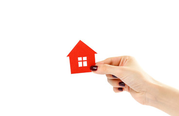 Fototapeta na wymiar The hand holds the red house. House in hands. Close up. Isolated on a white background