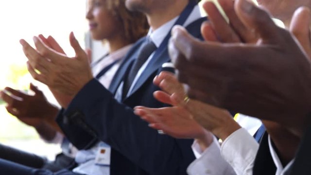 Close Up Of Delegates At Business Conference Applauding Speaker