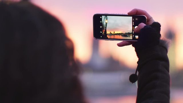 Woman Takes Photo Of Big Ben On Mobile Phone At Sunset
