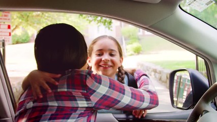 Mother In Car Dropping Off Daughter In Front Of School Gates