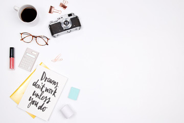 Woman workspace with handwritten quote notebook, vintage camera, coffee cup, lipstick and stationery on white background. Flat lay, top view. stylish female blogger concept.