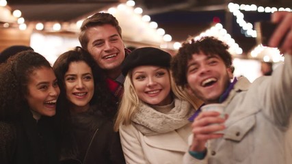 Young Friends Posing For Selfie At Christmas Market - Powered by Adobe