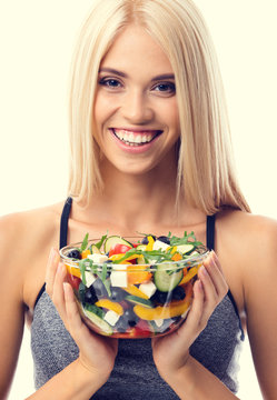 Woman in sportswear with salad