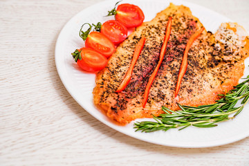 Roasted fish fillet with vegetables close