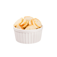 White ruddy sliced bread as croutons in white ceramics bowl isolated on white background. Fast food template for menu, advertising, cover.
