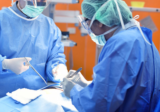 Team surgeon at work on operating room in hospital