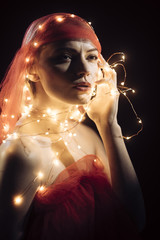 Girl with string with led lights around her body.