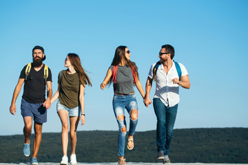 Fototapeta premium Four happy friends on mountains and having fun together