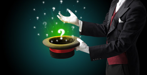 Magician conjure question signs from a cylinder