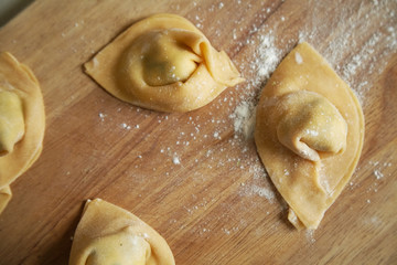 Overhead view of traditional italian handmade ravioli on cutting board