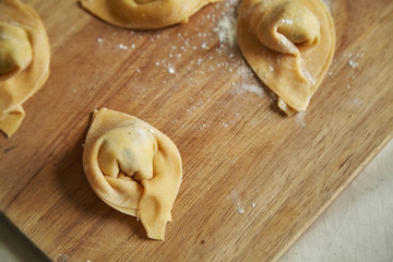 Overhead view of traditional italian handmade ravioli on cutting board