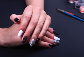 Black, white Nail art manicure. Holiday style bright Manicure with sparkles. Beauty hands. Stylish Nails, Nail Polish