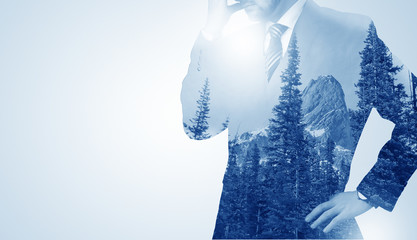 Businessman standing with mountain