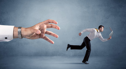 Businessman running from hand