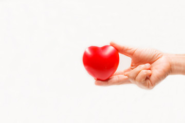 Heart shape in the helping hand on white background. Heart illness, disease protection, proactive checkup, mind diagnosis, sickness prevention, healthcare concept