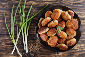 roasted hot meat cutlets on black plate