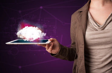 Woman holding tablet with cloud graphic