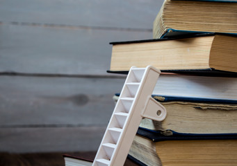 ladder on pile of old books