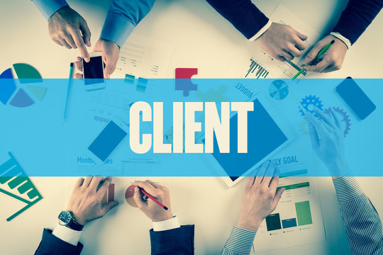 Business team working on desk with CLIENT word