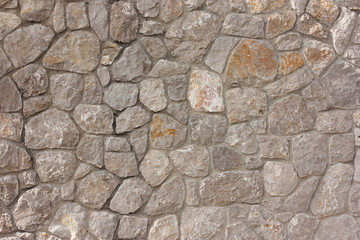  rough cobblestones in a row, brown background of natural stones