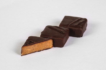 Cut handmade chocolate candy with filling isolated on white