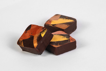 Handmade chocolate candy with filling isolated on white