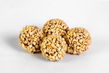 Chocolate candies with nuts on white background
