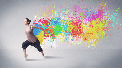 Obraz na płótnie Canvas Young colorful street dancer with paint splash