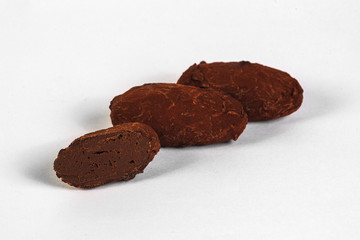 Cut handmade chocolate candy with filling isolated on white