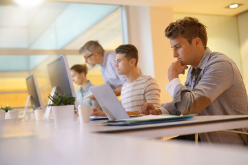 Students in class in front of desktop