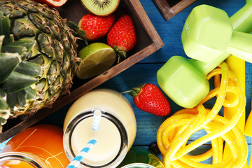 Healthy lifestyle concept. sport fitness equipment-several bottles with fruit and berry juices smoothies and milkshakes , jumping rope