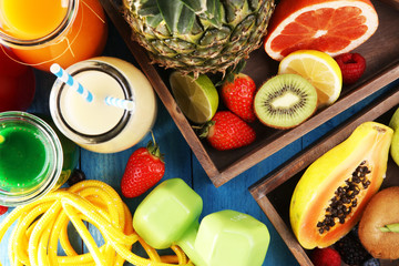 Healthy lifestyle concept. sport fitness equipment-several bottles with fruit and berry juices smoothies and milkshakes , jumping rope