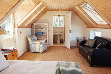 Interior of an attic bedroom with bathroom in a home