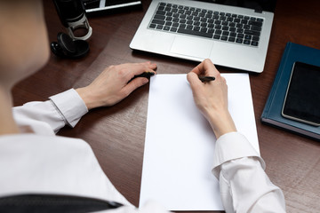 A businessman puts his signature on the contract. Copy space.