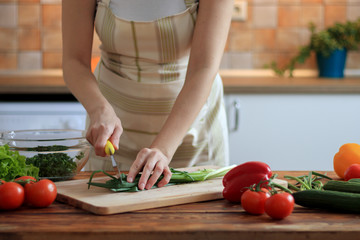 Woman make fresh salad on the kitchen