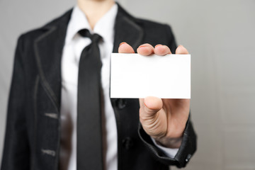 Businesswoman holding a business card. Mock up. Copy space.